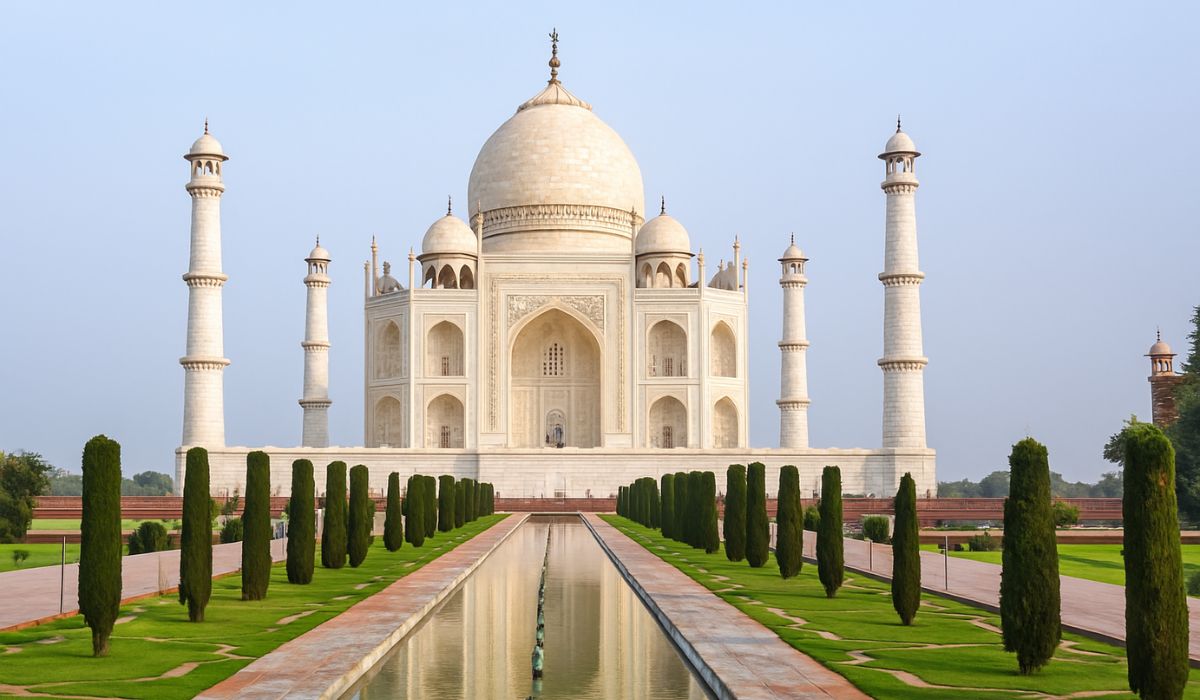 Front view of the Taj Mahal in daylight with reflecting pool and gardens during an Agra tour.